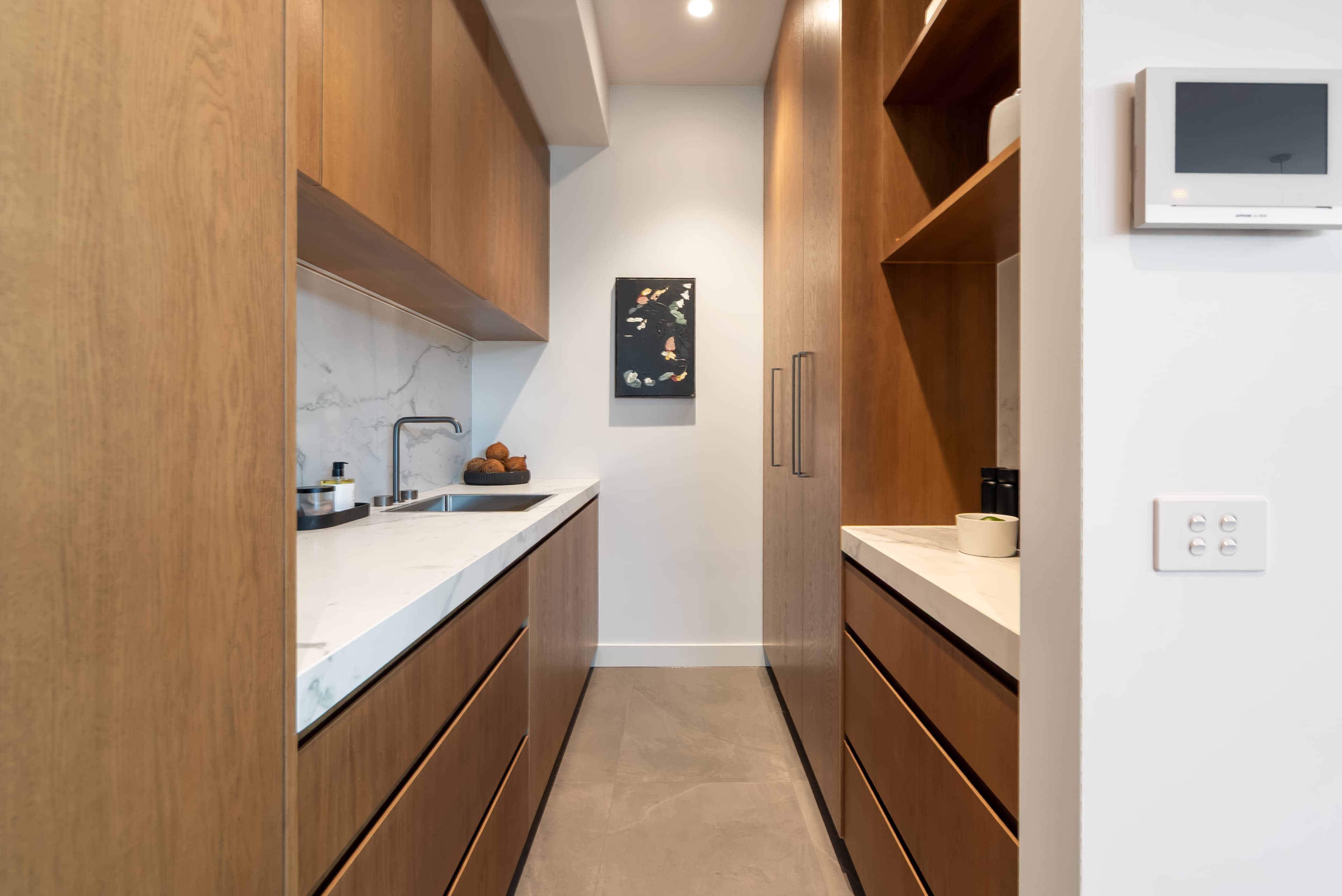 Butler's pantry with timber cabinetry and marble countertops